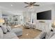 Open-concept living room with gray sectional sofa and light colored wood floors at 2539 Blue Crane Circle # 101, Myrtle Beach, SC 29577