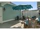 Outdoor patio featuring comfortable seating under a large blue umbrella, perfect for relaxation at 2539 Blue Crane Circle # 101, Myrtle Beach, SC 29577