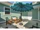 Inviting patio area with cozy furniture and an umbrella, ideal for outdoor relaxation and entertaining at 2539 Blue Crane Circle # 101, Myrtle Beach, SC 29577