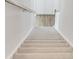 Carpeted staircase with white risers and a wooden handrail, providing a safe and stylish transition between floors at 2539 Blue Crane Circle # 101, Myrtle Beach, SC 29577