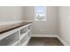 Bright laundry room with built-in shelving and a rustic wood countertop at 270 Russ Rd., Loris, SC 29569