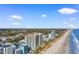 Expansive aerial view of beachfront condos and pristine beaches under a clear blue sky with scattered clouds at 2700 N Ocean Blvd. # 253, Myrtle Beach, SC 29577