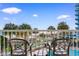 Balcony view overlooking the beach, palm trees, and the pool area below at 2700 N Ocean Blvd. # 253, Myrtle Beach, SC 29577