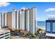 Beautiful exterior shot of the condos by the beach, featuring colorful balconies and lush landscaping at 2700 N Ocean Blvd. # 253, Myrtle Beach, SC 29577