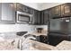 Kitchen featuring black appliances, granite countertops, and tiled backsplash at 2700 N Ocean Blvd. # 253, Myrtle Beach, SC 29577