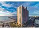 Exterior view of resort hotel featuring a pier, ocean views, and blue skies at 3500 N Ocean Blvd. # 501, North Myrtle Beach, SC 29582