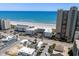 Aerial view of a beachfront community featuring condos, hotels, and a lively beach scene with clear ocean views at 3701 S Ocean Blvd. S # 206, North Myrtle Beach, SC 29582