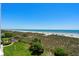 Panoramic beach view showcasing the sandy shoreline, clear ocean waters, and picturesque dunes with lush greenery at 3701 S Ocean Blvd. S # 206, North Myrtle Beach, SC 29582