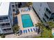 Aerial view of a refreshing swimming pool with lounge chairs, surrounded by lush landscaping and condo buildings at 3701 S Ocean Blvd. S # 206, North Myrtle Beach, SC 29582