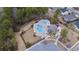 Aerial view of community pool with a large pool, a kiddie pool, sun loungers and surrounding lush landscaping at 3713 Park Pointe Ave., Little River, SC 29566