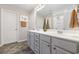 Bathroom featuring double sinks, a large mirror, decorative vases, and a walk-in shower at 3713 Park Pointe Ave., Little River, SC 29566