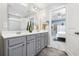 Bathroom with double sinks, a large mirror, decorative vases, and an open view to the main bedroom at 3713 Park Pointe Ave., Little River, SC 29566