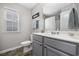 Neutral bathroom featuring a gray vanity, tile floor, and large mirror at 3713 Park Pointe Ave., Little River, SC 29566