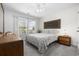 Cozy bedroom featuring a patterned bedspread, dresser, nightstand, and ample natural light at 3713 Park Pointe Ave., Little River, SC 29566