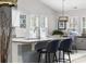 Bright kitchen featuring granite countertops, an island with bar stools, and ample natural light from multiple windows at 3713 Park Pointe Ave., Little River, SC 29566