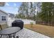 Outdoor patio area with a grill, table, and view of the fenced yard at 3713 Park Pointe Ave., Little River, SC 29566