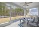 Cozy screened-in porch with seating, ceiling fan, and views of the yard at 3713 Park Pointe Ave., Little River, SC 29566