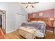 Comfortable bedroom featuring wood floors, ceiling fan, and unique wood headboard at 3931 East Glades Dr., Myrtle Beach, SC 29588