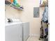 Practical laundry room with a washer, dryer, and convenient overhead storage at 3931 East Glades Dr., Myrtle Beach, SC 29588