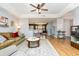 Open-concept living room with a decorative rug, hardwood floors, and a view into the kitchen at 3931 East Glades Dr., Myrtle Beach, SC 29588