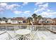 Patio set on a beautiful wooden deck overlooking well maintained neighboring homes at 3931 East Glades Dr., Myrtle Beach, SC 29588