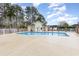 Community pool surrounded by white picket fence and mature trees at 3931 East Glades Dr., Myrtle Beach, SC 29588