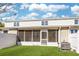 Back exterior view showing the screened porch and AC unit at 3983 Tybre Downs Circle # 3983, Little River, SC 29566