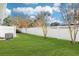 Landscaped backyard with a white privacy fence at 3983 Tybre Downs Circle # 3983, Little River, SC 29566