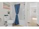 Clean bathroom with a tub shower combo and blue shower curtain at 3983 Tybre Downs Circle # 3983, Little River, SC 29566