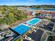 Aerial view of tennis and basketball courts with waterfront condos nearby at 4396 Baldwin Ave. # 94, Little River, SC 29566