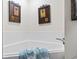 Relaxing bathtub area with stylish tile surround and towel with seashells at 4396 Baldwin Ave. # 94, Little River, SC 29566