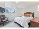 Cozy bedroom with soft natural light, a comfortable bed, and a quaint reading chair at 4396 Baldwin Ave. # 94, Little River, SC 29566