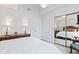 Bedroom with a mirrored closet door and white patterned bedding at 4396 Baldwin Ave. # 94, Little River, SC 29566