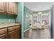 Breakfast nook with wooden cabinets, bright windows, and cozy round table at 4396 Baldwin Ave. # 94, Little River, SC 29566