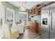 Breakfast nook with wooden cabinets, stainless steel fridge, and bright windows at 4396 Baldwin Ave. # 94, Little River, SC 29566