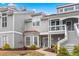 Charming townhome featuring gray siding, a bay window, and covered porch, enhancing curb appeal at 4396 Baldwin Ave. # 94, Little River, SC 29566