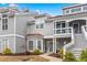 Charming two-story condo featuring gray shingles, red accents, and a welcoming front entrance with a cozy balcony at 4396 Baldwin Ave. # 94, Little River, SC 29566