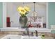 View of the dining room from kitchen featuring a vase of sunflowers and pendant lighting at 4396 Baldwin Ave. # 94, Little River, SC 29566