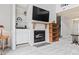 Bright living room featuring a fireplace, TV, and shelving at 4396 Baldwin Ave. # 94, Little River, SC 29566