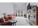 Bright living room featuring a fireplace, TV, and access to the patio at 4396 Baldwin Ave. # 94, Little River, SC 29566