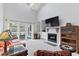 Bright living room featuring a fireplace, TV, and sliding glass doors to a patio at 4396 Baldwin Ave. # 94, Little River, SC 29566