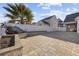 Spacious backyard featuring a waterfall feature with brick paver patio and white fence at 455 Blackberry Ln., Myrtle Beach, SC 29579