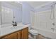 Bathroom with standard tub, toilet and wood cabinet vanity with white countertop at 455 Blackberry Ln., Myrtle Beach, SC 29579