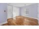 Bedroom featuring wood floors, a window, a double door closet, and light purple walls at 455 Blackberry Ln., Myrtle Beach, SC 29579