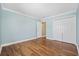 Bedroom featuring wood floors, a double door closet, and a light blue painted wall at 455 Blackberry Ln., Myrtle Beach, SC 29579