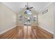 Bright living room with vaulted ceilings, hardwood floors, fan, and sliding glass doors at 455 Blackberry Ln., Myrtle Beach, SC 29579