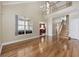 Open-concept living room with wood floors, a view of the staircase, and abundant natural light at 455 Blackberry Ln., Myrtle Beach, SC 29579