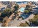 Aerial view of a community pool, playground, clubhouse, and ample parking surrounded by mature trees at 4783 Southgate Pkwy., Myrtle Beach, SC 29579