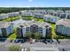 Aerial view of condo community highlighting central lake with lush landscaping and ample parking at 4851 Luster Leaf Circle # 302, Myrtle Beach, SC 29577