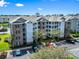 Stunning aerial view of a condo complex with manicured landscaping, parking, and a view of a pond at 4851 Luster Leaf Circle # 302, Myrtle Beach, SC 29577